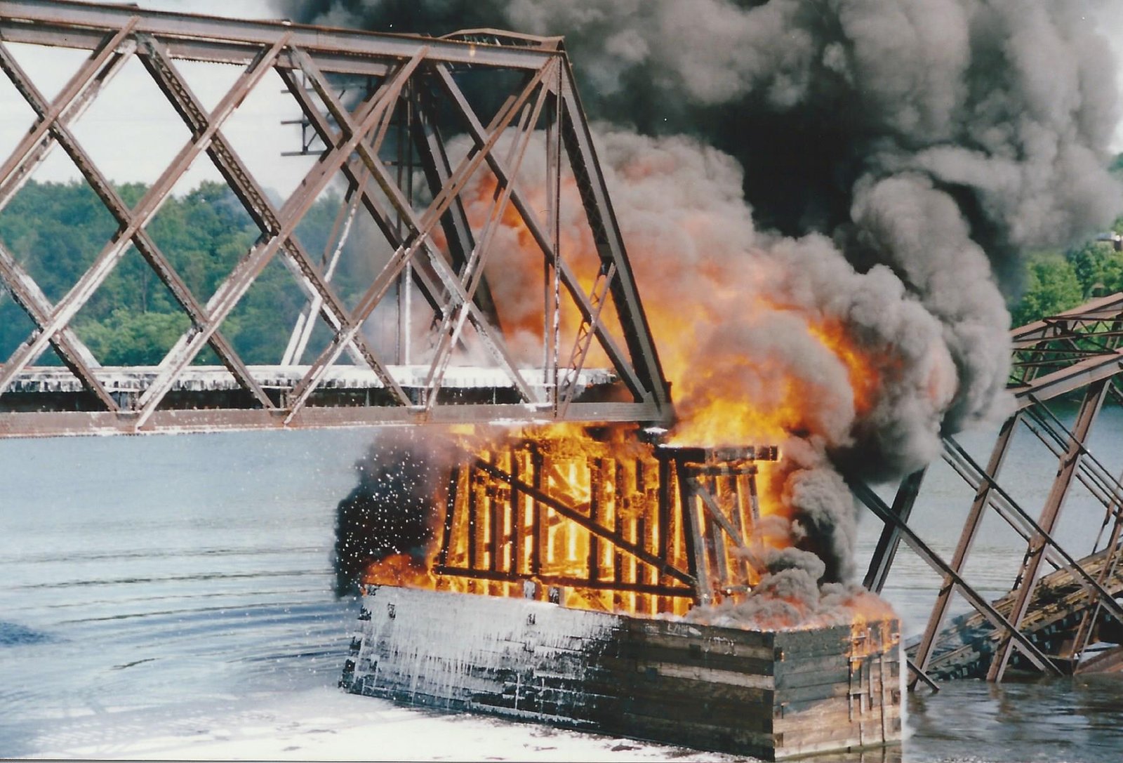 Pier still burning, with one span collapsed.  Tom Larson photo